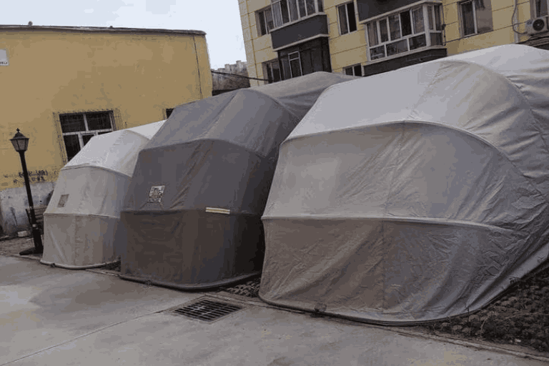 Row of grey foldable car shelters | housetopic