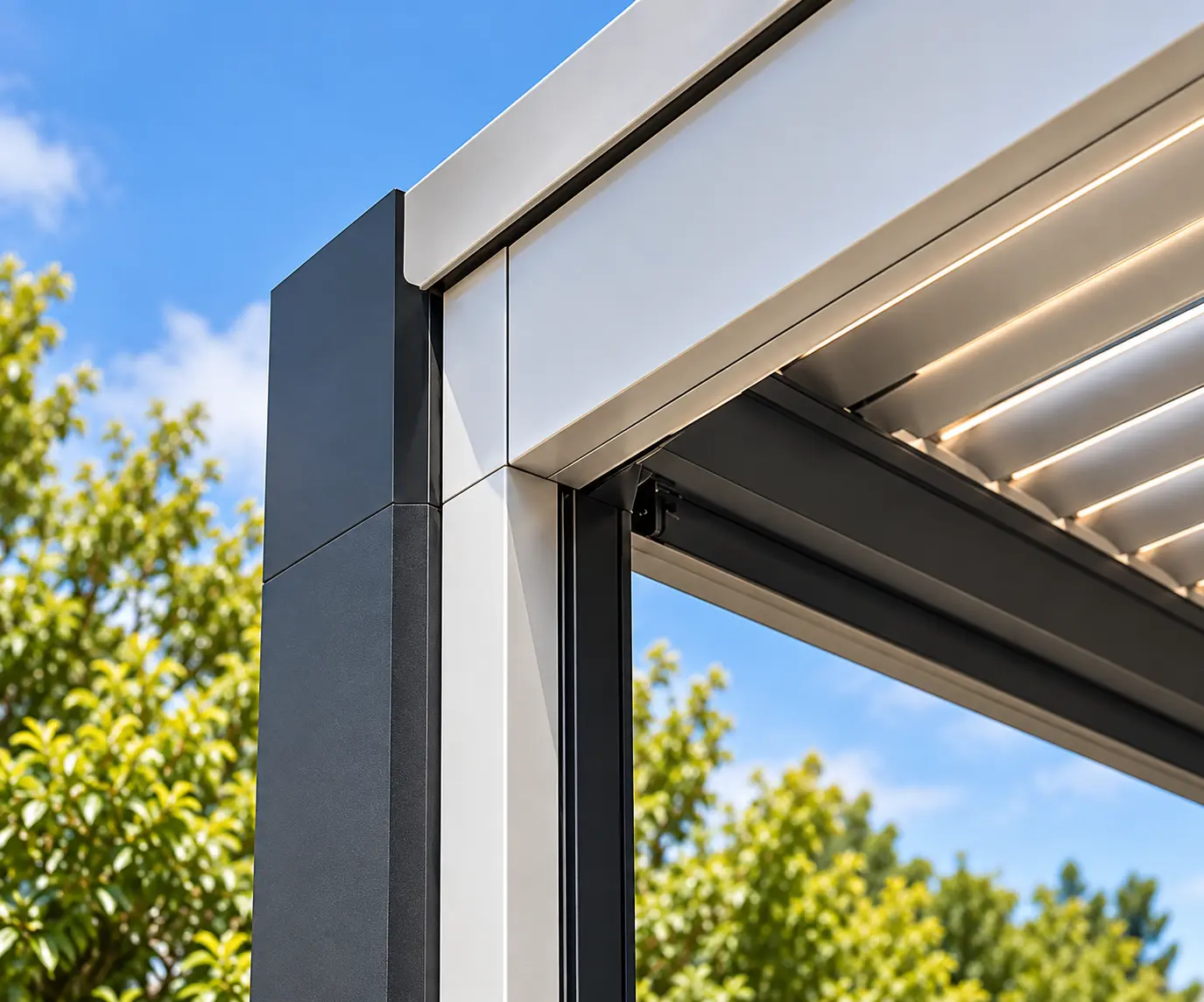 Close-up of a louvered pergola frame showing the built-in drainage system